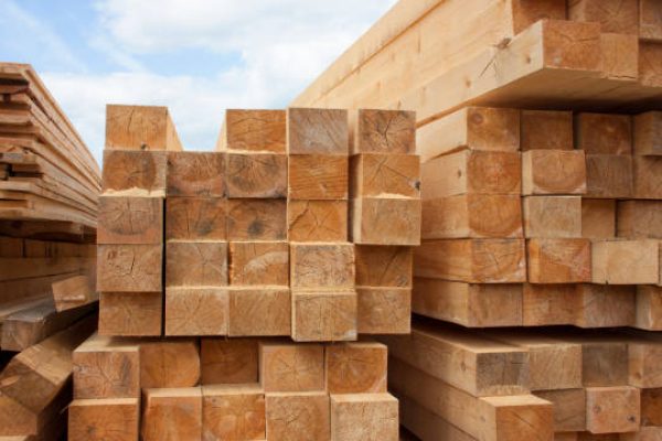 Lumber warehouse. Wood planks and timber stacked in stacks outdoors